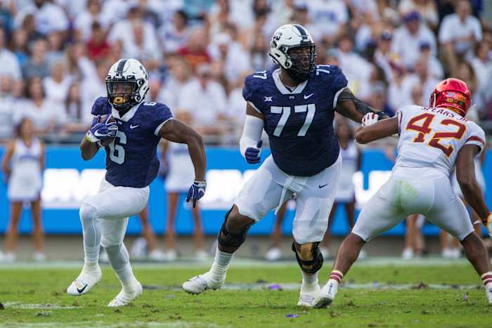 Sep 29, 2018; Fort Worth, TX, USA; TCU Horned Frogs running back Darius Anderson (6) and offensive tackle Lucas Niang (77) in action during the game against the Iowa State Cyclones at Amon G. Carter Stadium.